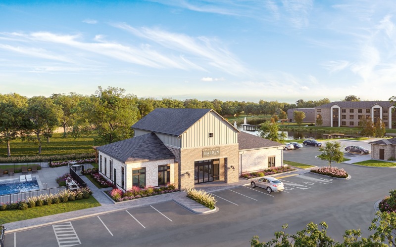 a leasing office with cars in a parking lot